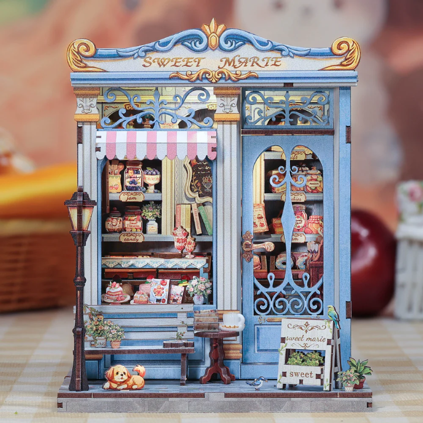 Diorama of a pastry shop detailed with lights.